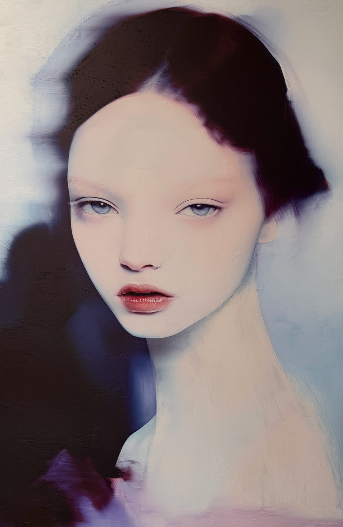 “MEETH 05” by Giuseppe Scarangelli, mixed media on aluminium panel, 150×100 cm, 2025. A large-scale contemporary portrait depicting a young woman with an ethereal, almost translucent complexion. Her features are softly rendered with delicate shading, while blurred contours around her hair and shoulders create a sense of motion and dreamlike atmosphere. The composition uses cool blue, violet, and muted grey tones, contrasted by dark details framing the face. The work blends realism with abstraction, giving the figure a haunting, otherworldly presence.